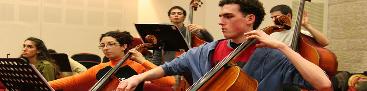 Students practicing music with cellos and upright basses