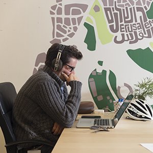Person working at a computer with headphones