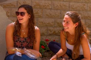 Two female students sharing a laugh
