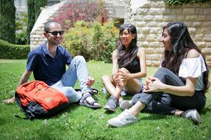 Students sitting on lawn at HebrewU
